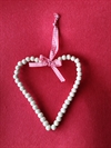 Et stk dekorations hjerte . Træ perler.  Til evt. ophængning. Ca.15 cm