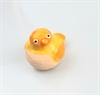 Lille gul/orange keramik fugl ca. 4 cm. høj.