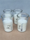 4 stk. advents hvid lys i glas. Med tallene 1,2,3,og 4. Med lille nisse på glasset. Ca. H. 10 cm. Ø 6 cm.