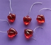 5 stk. Akryl røde hjerter med tråd. Ca. 2 cm. Tykkelse ca 1 cm.